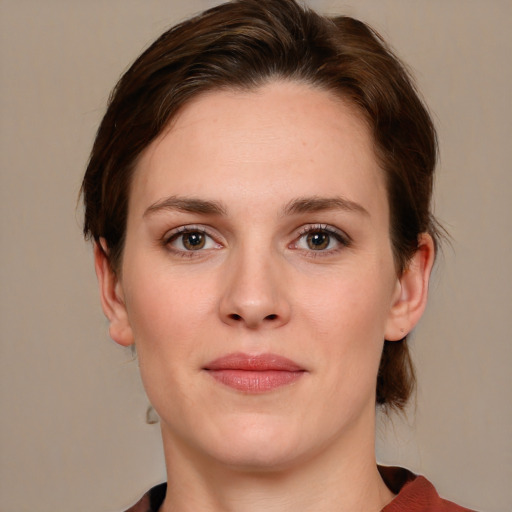 Joyful white young-adult female with medium  brown hair and grey eyes