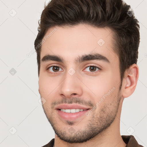 Joyful white young-adult male with short  brown hair and brown eyes