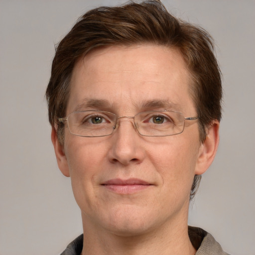 Joyful white adult male with short  brown hair and grey eyes