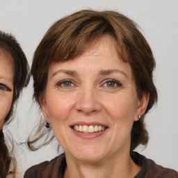 Joyful white adult female with medium  brown hair and brown eyes