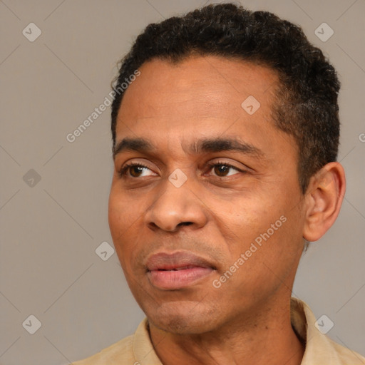 Joyful latino adult male with short  black hair and brown eyes