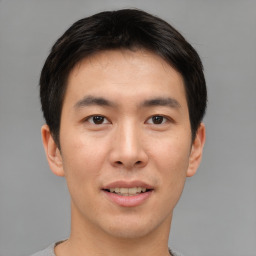 Joyful asian young-adult male with short  brown hair and brown eyes