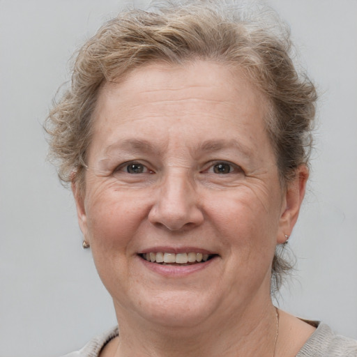 Joyful white adult female with short  brown hair and grey eyes