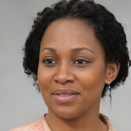 Joyful black adult female with medium  brown hair and brown eyes