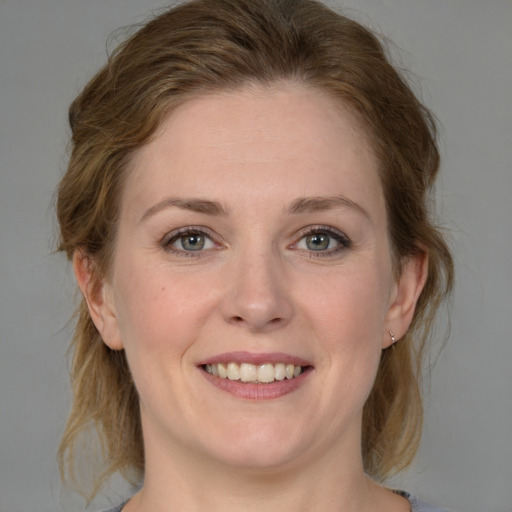 Joyful white young-adult female with medium  brown hair and blue eyes