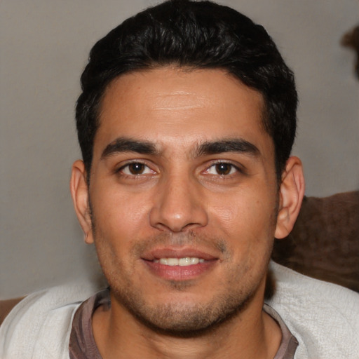Joyful white young-adult male with short  black hair and brown eyes