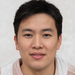 Joyful asian young-adult male with short  brown hair and brown eyes