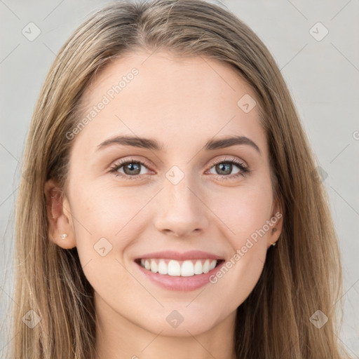 Joyful white young-adult female with long  brown hair and blue eyes