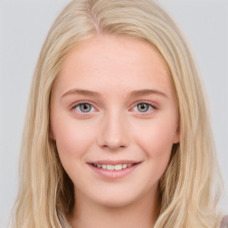 Joyful white young-adult female with long  brown hair and blue eyes