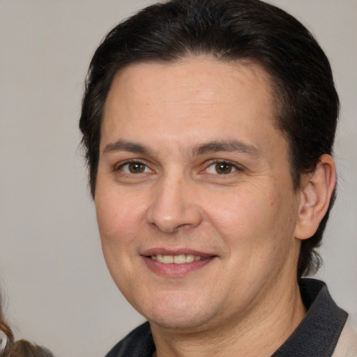 Joyful white adult male with medium  brown hair and brown eyes