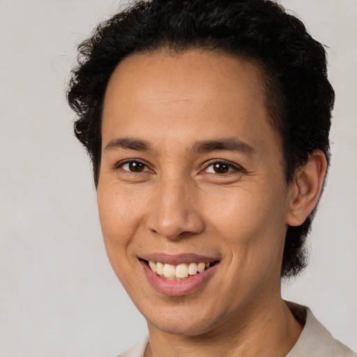 Joyful latino young-adult male with short  brown hair and brown eyes