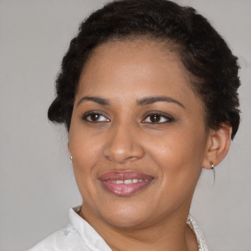 Joyful black adult female with short  brown hair and brown eyes