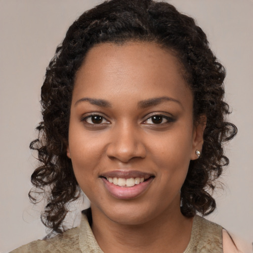 Joyful black young-adult female with medium  brown hair and brown eyes