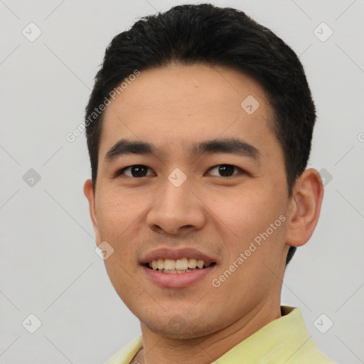 Joyful asian young-adult male with short  black hair and brown eyes