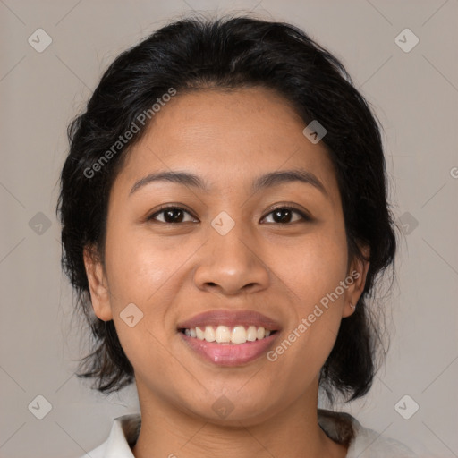 Joyful latino young-adult female with medium  brown hair and brown eyes