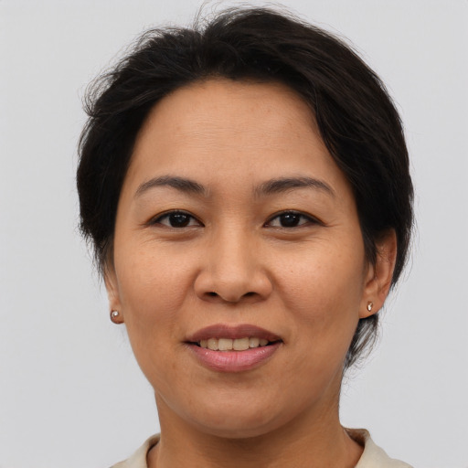 Joyful asian adult female with medium  brown hair and brown eyes