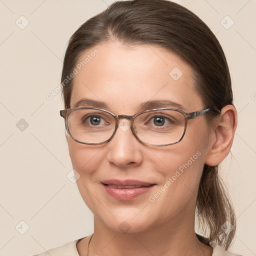 Joyful white young-adult female with medium  brown hair and grey eyes