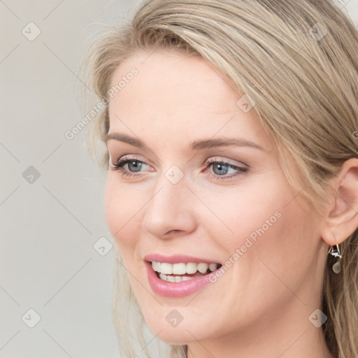 Joyful white young-adult female with long  brown hair and blue eyes