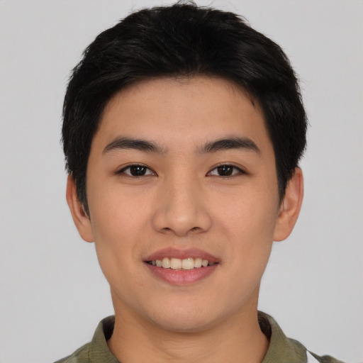 Joyful asian young-adult male with short  black hair and brown eyes