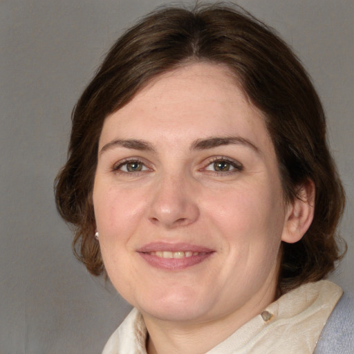 Joyful white adult female with medium  brown hair and brown eyes