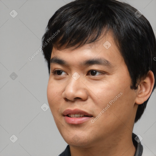 Joyful asian young-adult male with short  black hair and brown eyes