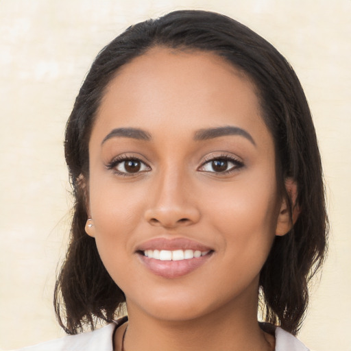 Joyful latino young-adult female with medium  black hair and brown eyes