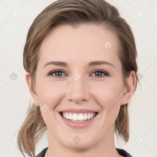 Joyful white young-adult female with medium  brown hair and grey eyes