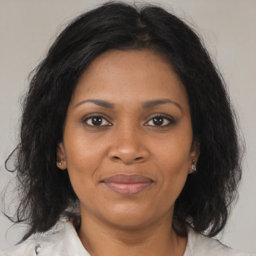 Joyful black adult female with medium  brown hair and brown eyes