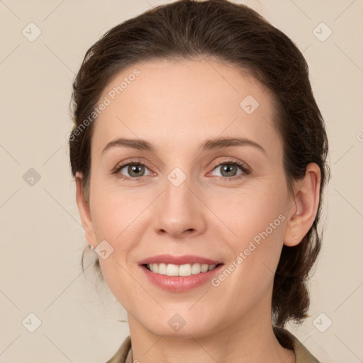 Joyful white young-adult female with medium  brown hair and green eyes