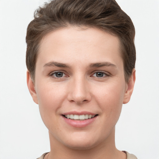 Joyful white young-adult female with short  brown hair and grey eyes