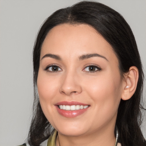 Joyful white young-adult female with medium  black hair and brown eyes