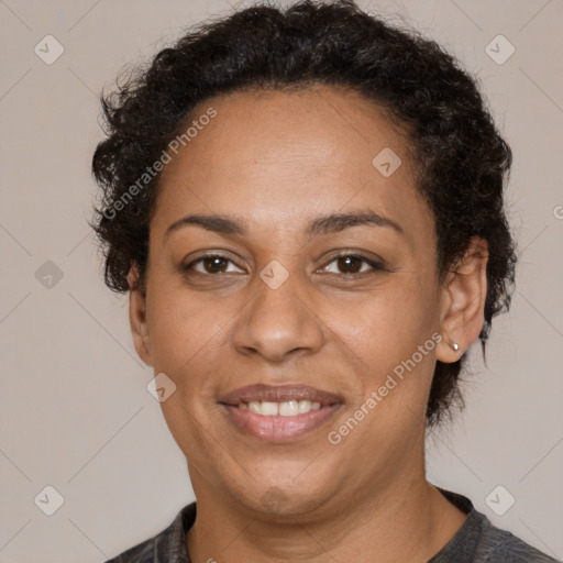 Joyful black adult female with short  brown hair and brown eyes