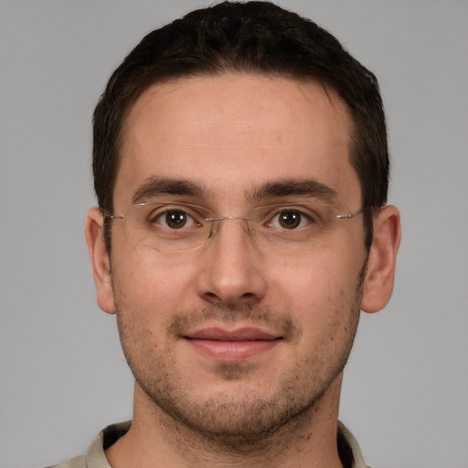 Joyful white young-adult male with short  brown hair and brown eyes