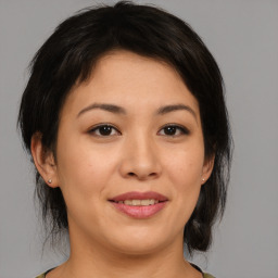 Joyful asian young-adult female with medium  brown hair and brown eyes