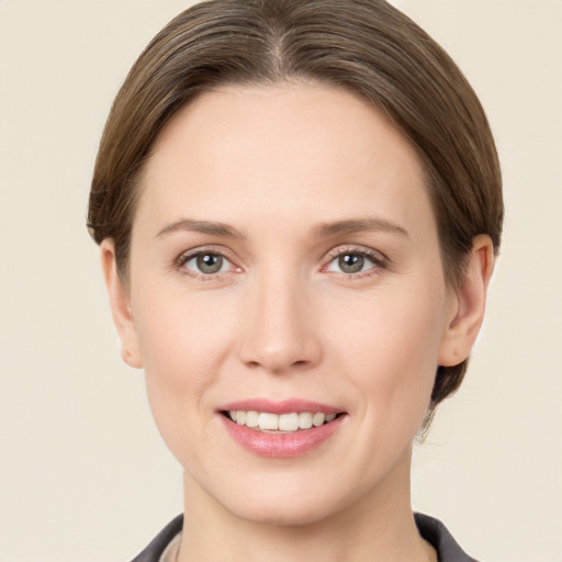 Joyful white young-adult female with short  brown hair and grey eyes