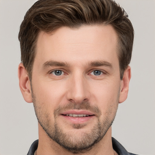 Joyful white young-adult male with short  brown hair and grey eyes