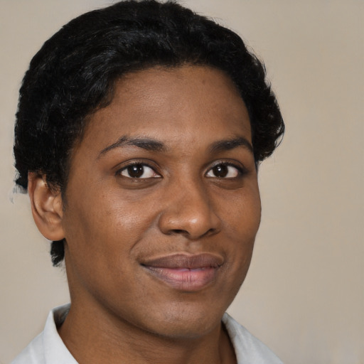 Joyful black young-adult female with short  black hair and brown eyes