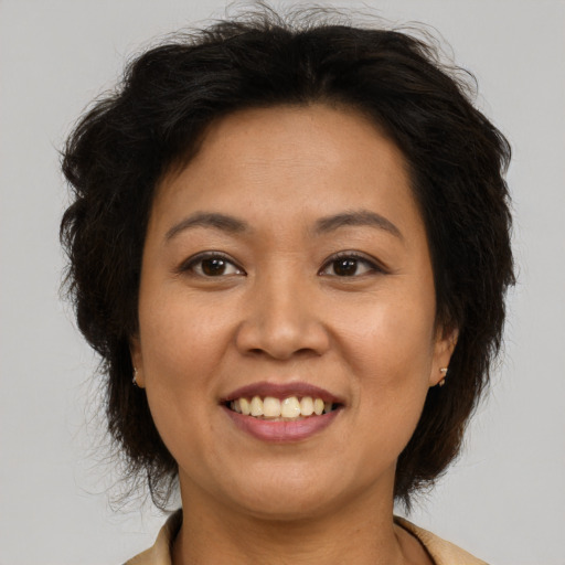 Joyful latino adult female with medium  brown hair and brown eyes