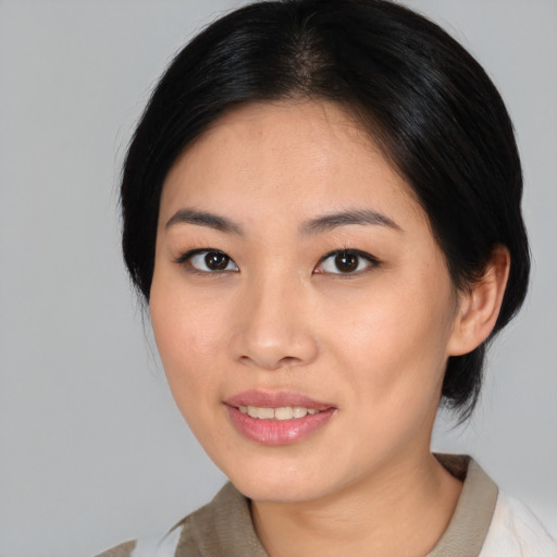 Joyful asian young-adult female with medium  black hair and brown eyes