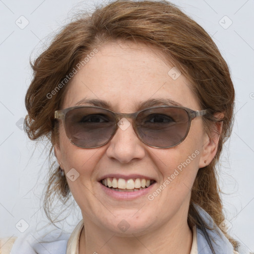 Joyful white adult female with medium  brown hair and blue eyes