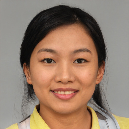 Joyful asian young-adult female with medium  black hair and brown eyes