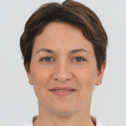 Joyful white adult female with short  brown hair and brown eyes