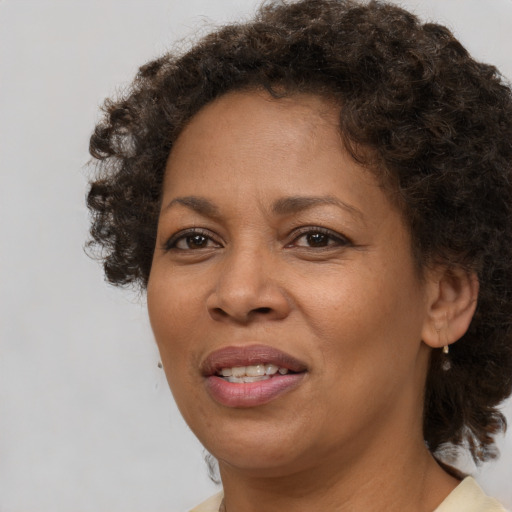 Joyful black adult female with short  brown hair and brown eyes