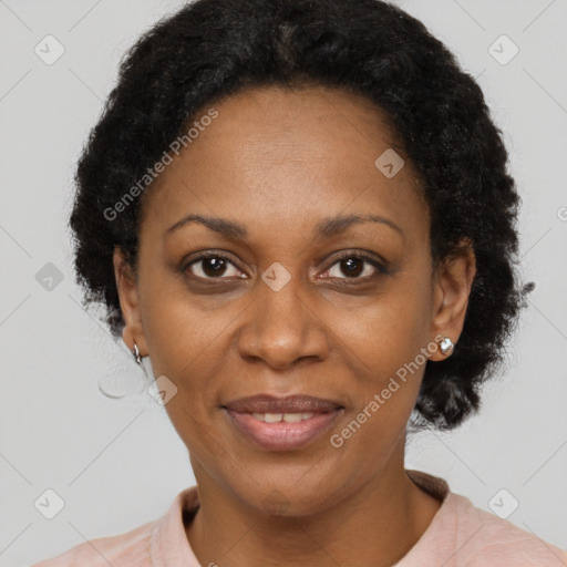 Joyful black adult female with short  black hair and brown eyes