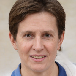 Joyful white adult female with medium  brown hair and grey eyes