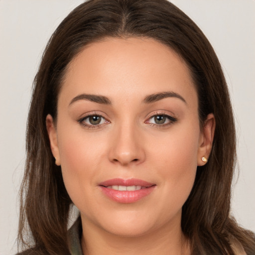 Joyful white young-adult female with long  brown hair and brown eyes