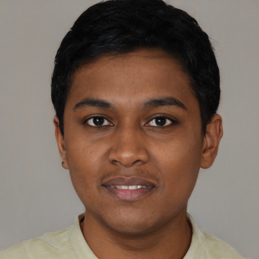 Joyful black young-adult male with short  black hair and brown eyes