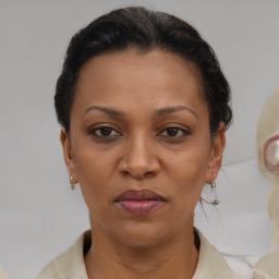 Joyful black adult female with short  brown hair and brown eyes