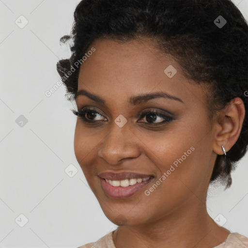 Joyful black young-adult female with short  brown hair and brown eyes