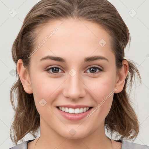 Joyful white young-adult female with medium  brown hair and grey eyes